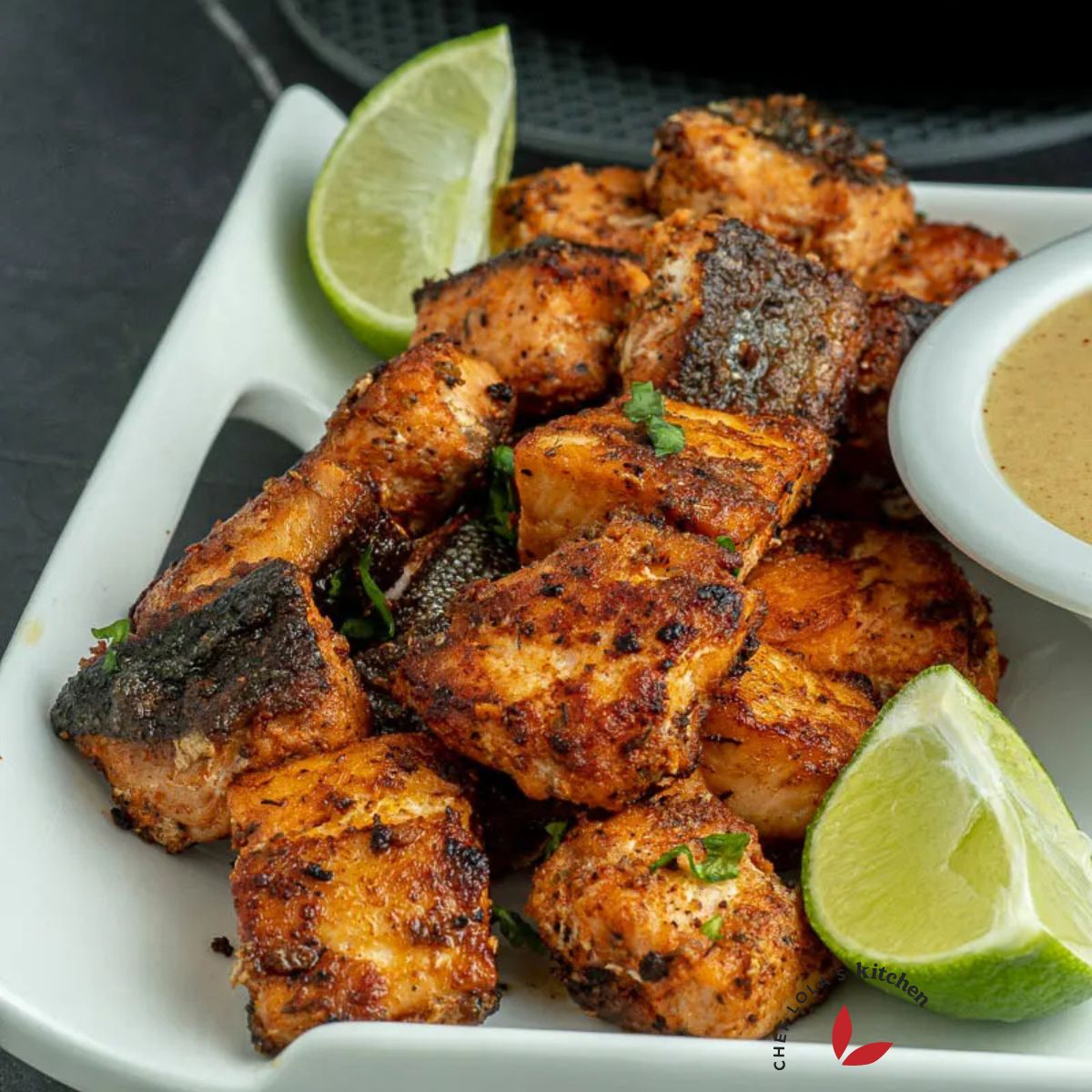 Delicious salmon bites garnished with lemon wedges