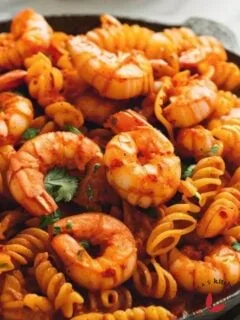 Homemade Spicy shrimp pasta cooked in a skillet and garnished with parsley