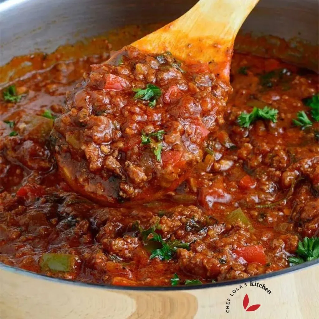 Close look on Pasta sauce scooped with a wooden spoon from a pot