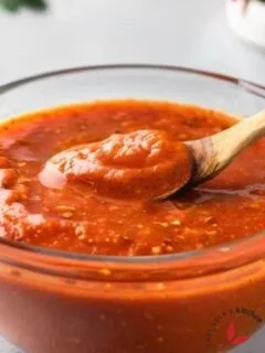 Peri peri sauce scooped with a spoon to show it's beautiful texture.