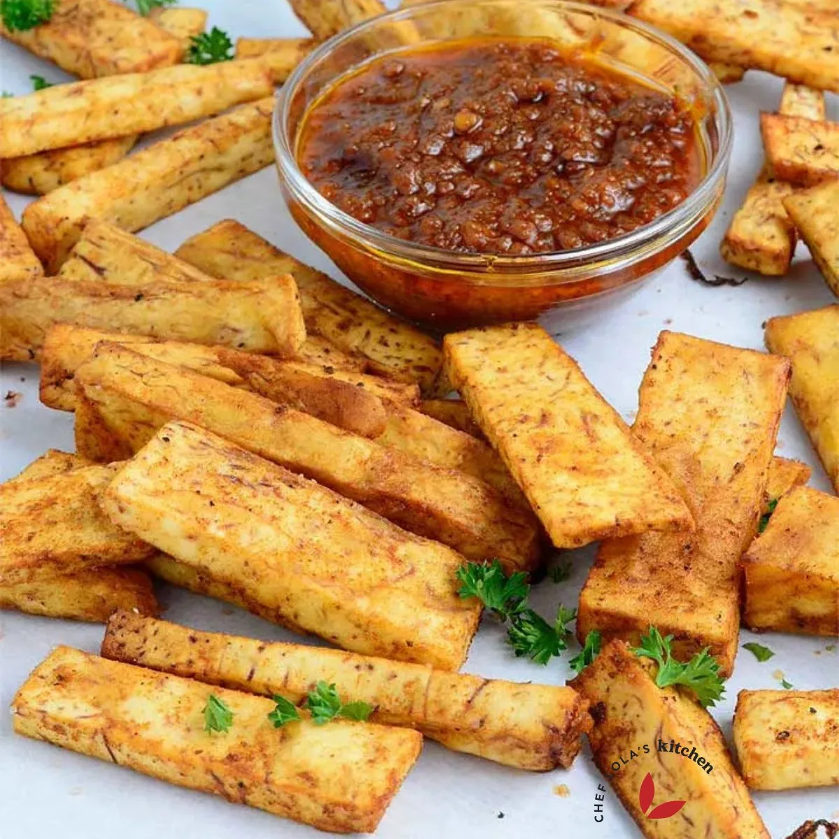 Taro root fries on a parchment paper with pepper sauce