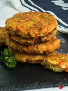 Salmon croquettes with lemon wedges and parsely