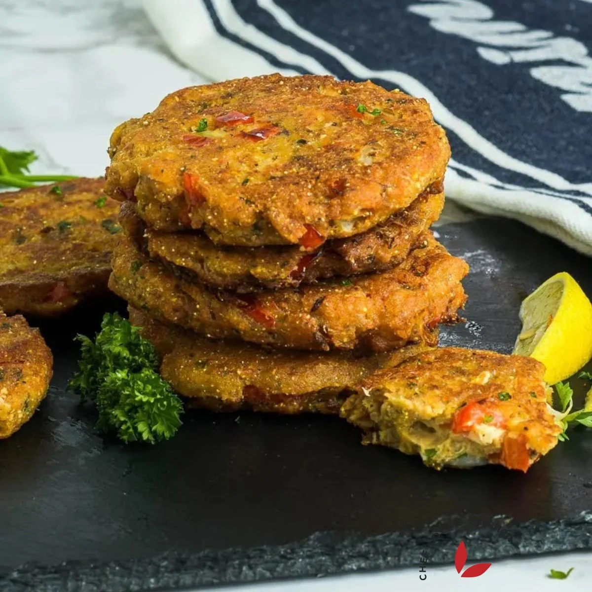 Salmon croquettes with lemon wedges and parsely
