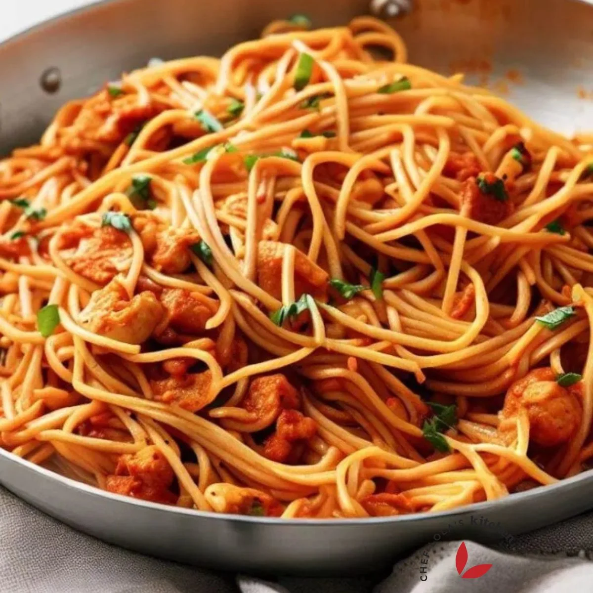 A delicious pot of chicken spaghetti garnished with parsley