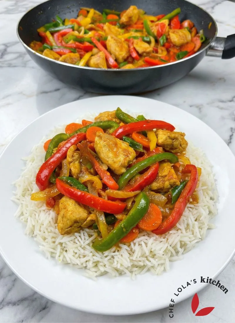 Healthy chicken stir fry with vegetables and thick sauce served on white rice