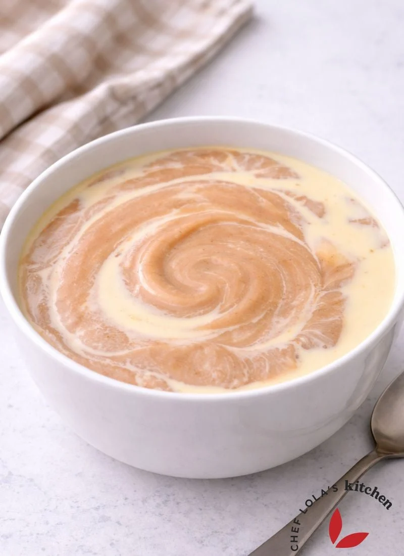 Homemade Pap in a bowl, showing its thick and smooth consistency with milk drizzled on top.
