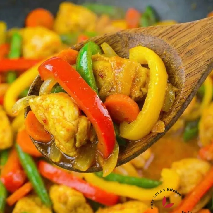 Stir-fried chicken with mixed vegetables coated in glossy sauce