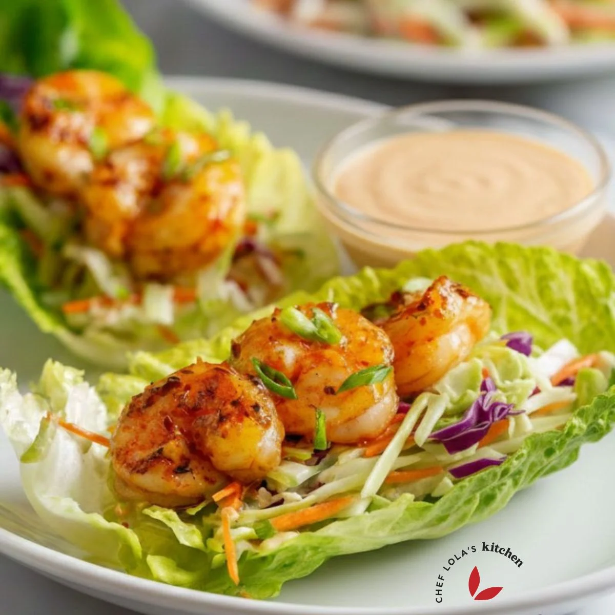 Fresh lettuce cups stuffed with sautéed shrimp and colorful toppings.