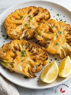 Oven-baked cauliflower steak with caramelized surface, garnished with parsley