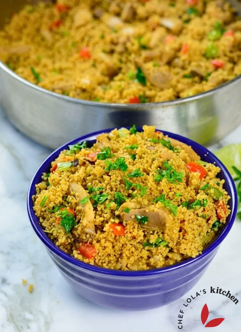 Healthy chicken and vegetable couscous plated neatly with fresh greens and spices