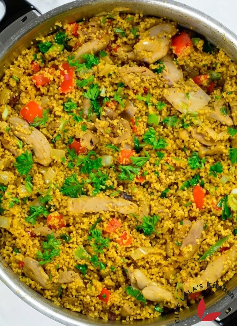 A homemade chicken vegetable couscous dish featuring soft grains, juicy chicken, and vibrant vegetables.